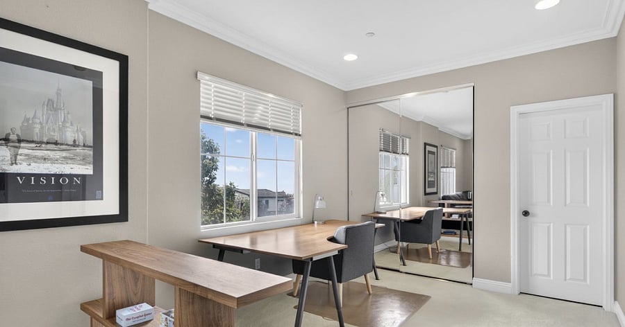 Upstairs den features a large dedicated desk and workspace, ideal for working from home, remote meetings, or focused study in a quiet, comfortable setting, along with a comfortable sofa for lounging and relaxation.