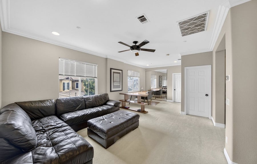 Upstairs den features a large dedicated desk and workspace, ideal for working from home, remote meetings, or focused study in a quiet, comfortable setting, along with a comfortable sofa for lounging and relaxation.
