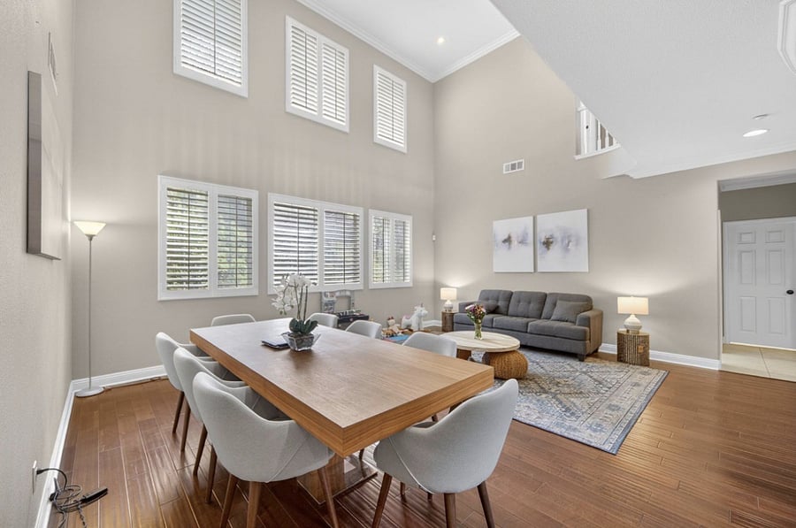 Downstairs features a spacious dining are with large dining table, along with a comfortable sofa for lounging and relaxing in a welcoming, open living space.