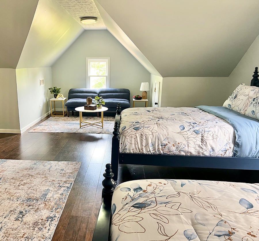 3rd floor loft with 2 full-sized beds and sitting area