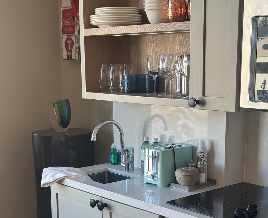 Fully stocked kitchenette: dinnerware, glassware, microwave/convection mini-oven, freezer, mini-refrigerator, beverage/wine chiller.