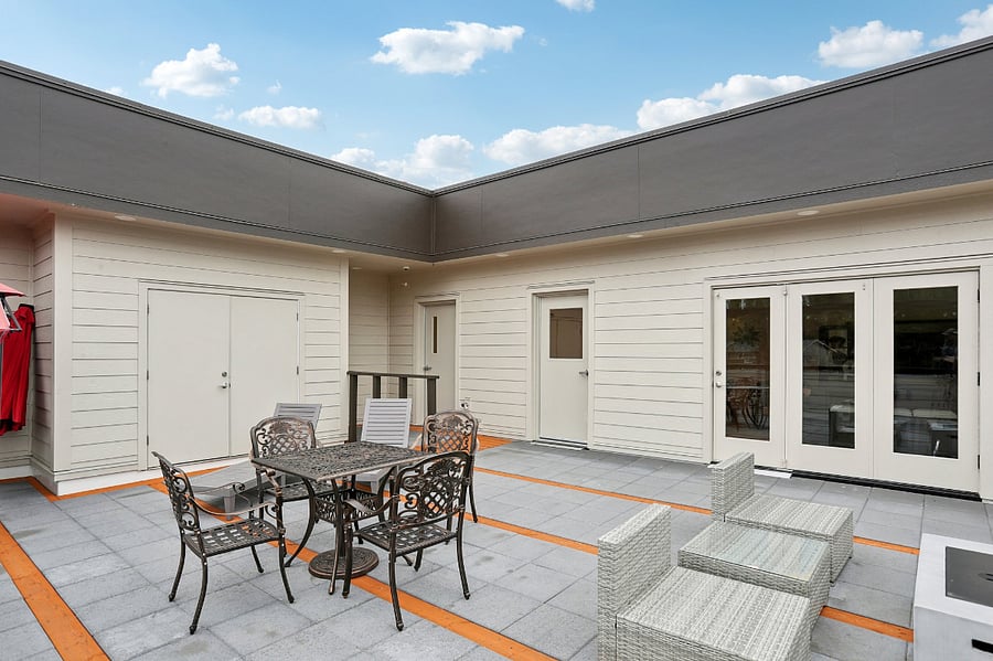 Roof-top patio with seating, propane coffee table, propane heater and a propane grill for use.