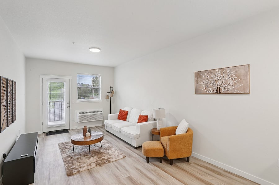 Living space with sofa and coffee table - TV will be provided.