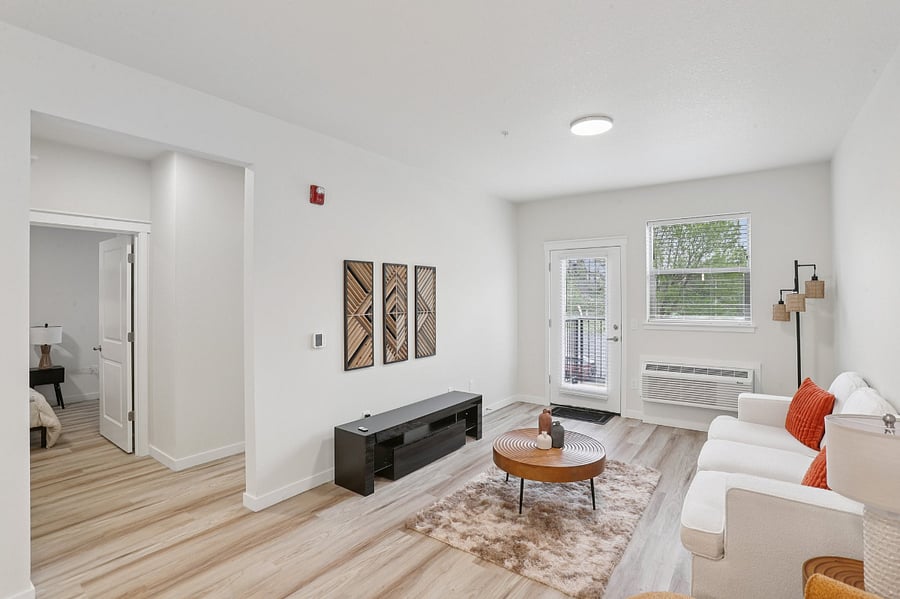 Living space with sofa and coffee table - TV will be provided.