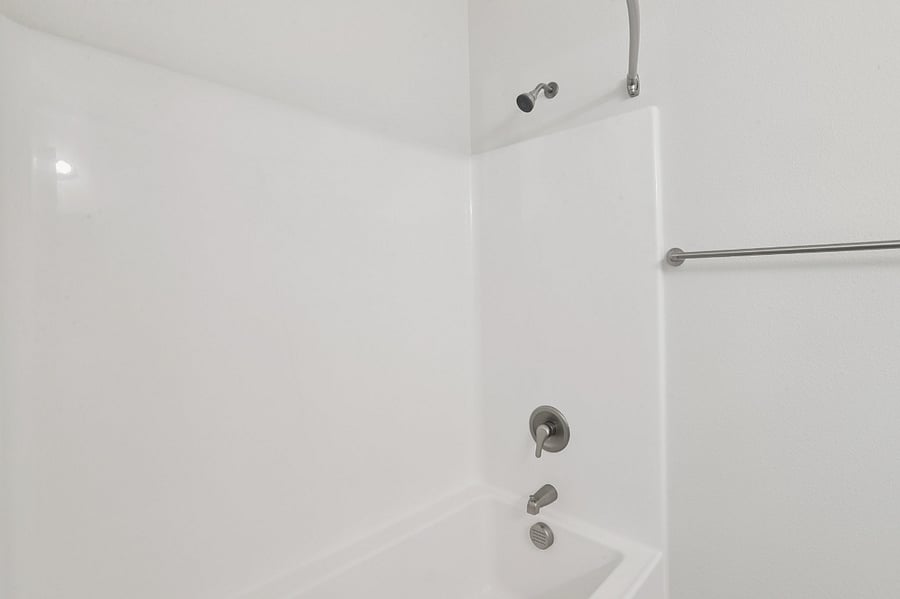 Main bathroom off entry way with vanity, toilet, and shower/tub combo.