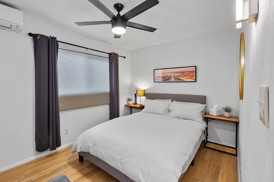 Bedroom 2 with blackout curtains and charging station