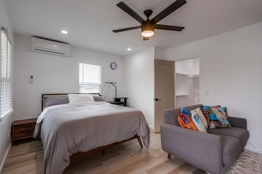 Spacious and peaceful primary suite featuring a comfortable bed, natural light, ample storage, and a relaxing atmosphere designed for extended stays.