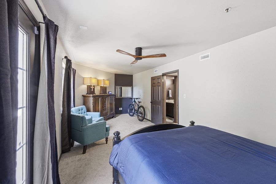 Primary Bedroom w/Mtn Bike, Sitting Chairs and Armoire