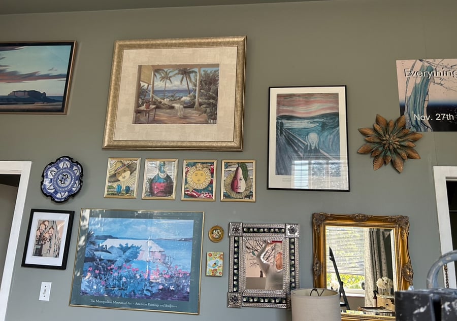 Theres plenty of artwork throughout the unit, We call ourselves, SoMA Because it is short for the Soulard Museum of art, to the right of this wall is the door to enter to the left of this wall is the door to the laundry room