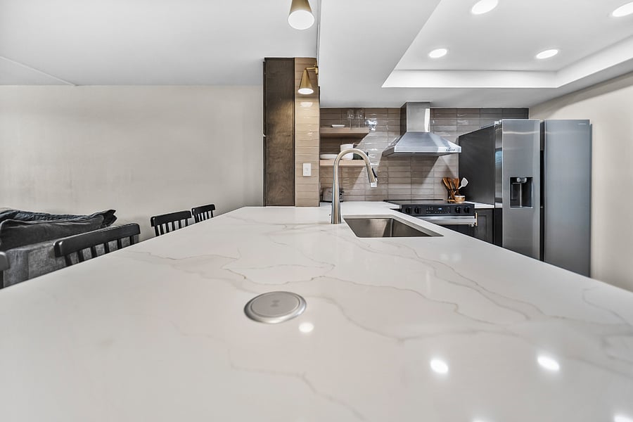 Over sized island with pop-up utility for extra charging and work appliances.
