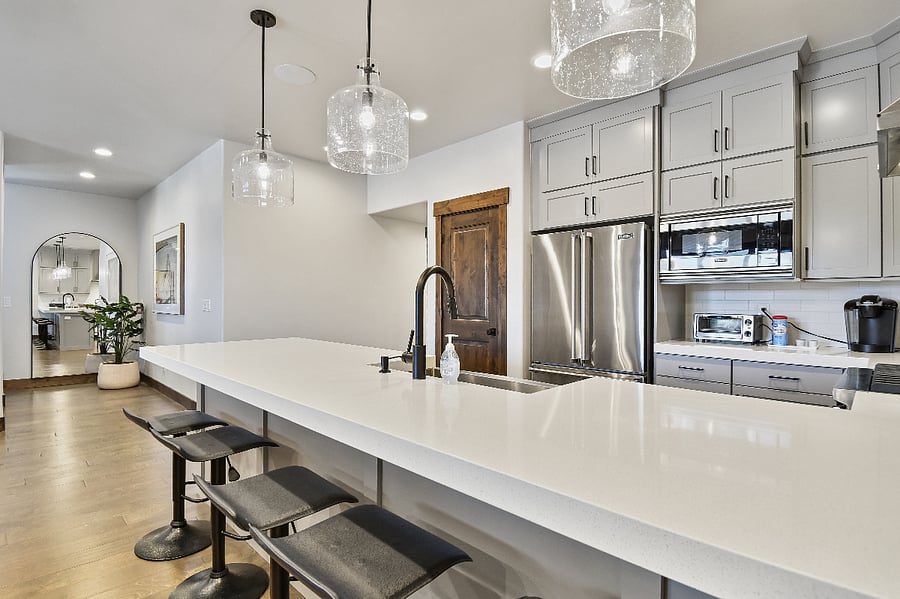 Seating for five at the kitchen island, where friends can visit and watch the chef prepare meals