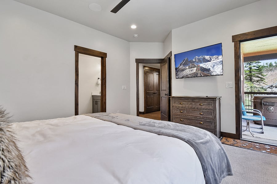 Master Suite 2 with a king bed, TV, and outdoor access to deck - Middle/Main Floor
