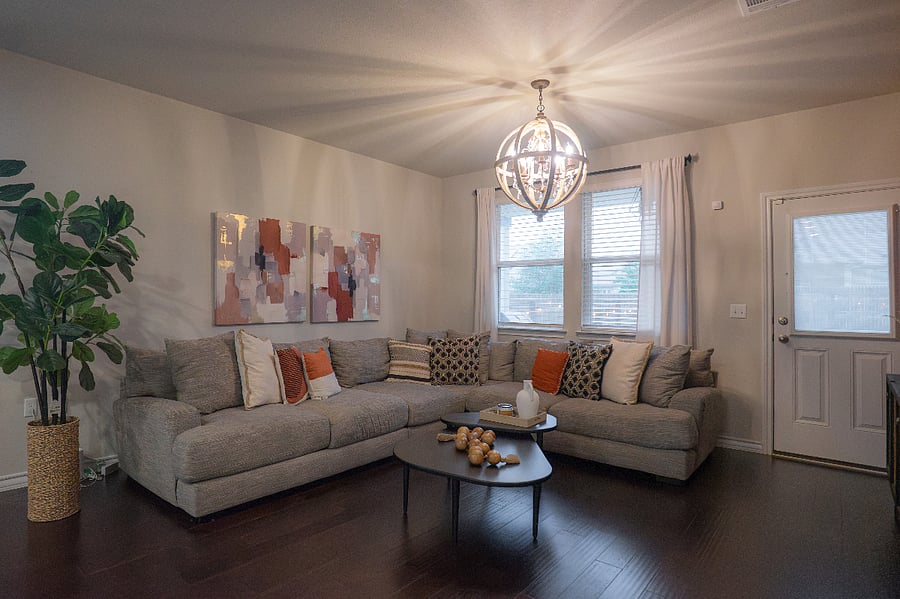 Bright open living room with statement chandelier and eclectic dcor