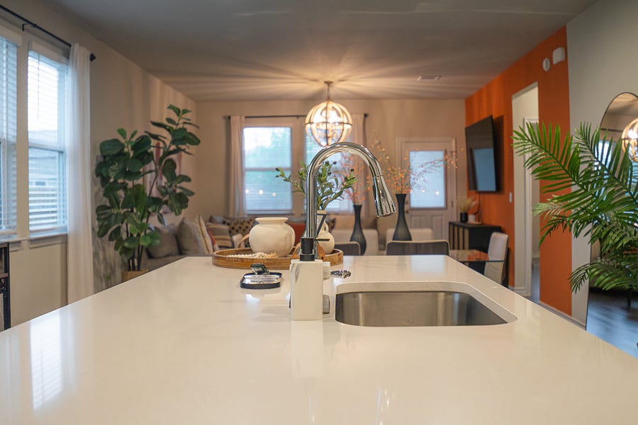 Kitchen island with curated tray styling, looking out to the living room