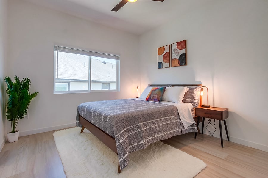 Bright and cozy guest bedroom thoughtfully furnished for comfort, making it ideal for family members, roommates, or visiting guests
