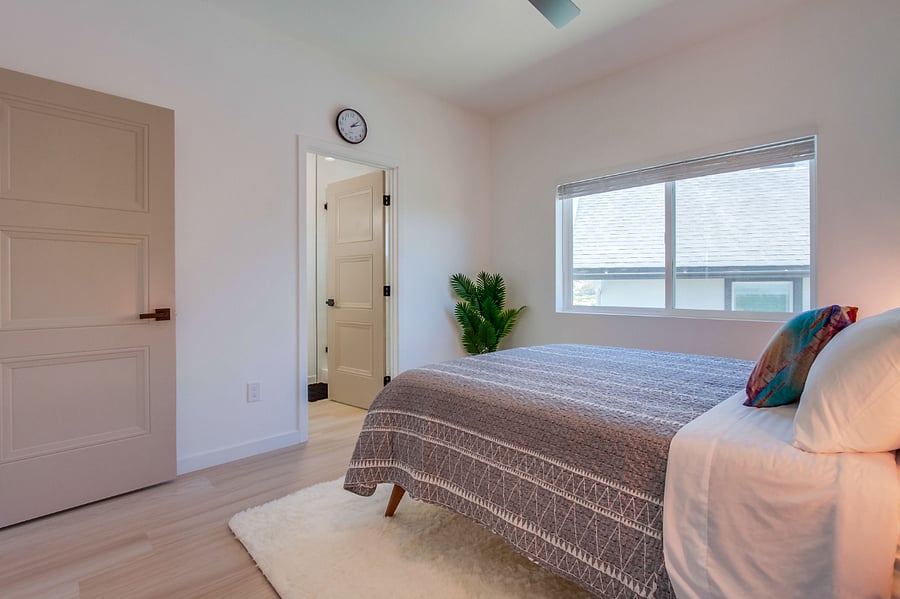 Bright and cozy guest bedroom thoughtfully furnished for comfort, making it ideal for family members, roommates, or visiting guests