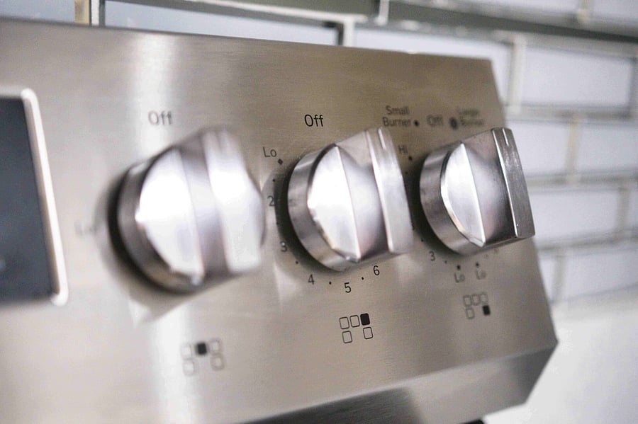 Close-up of the stove knobs highlighting the thoughtful design and attention to detail throughout the space.