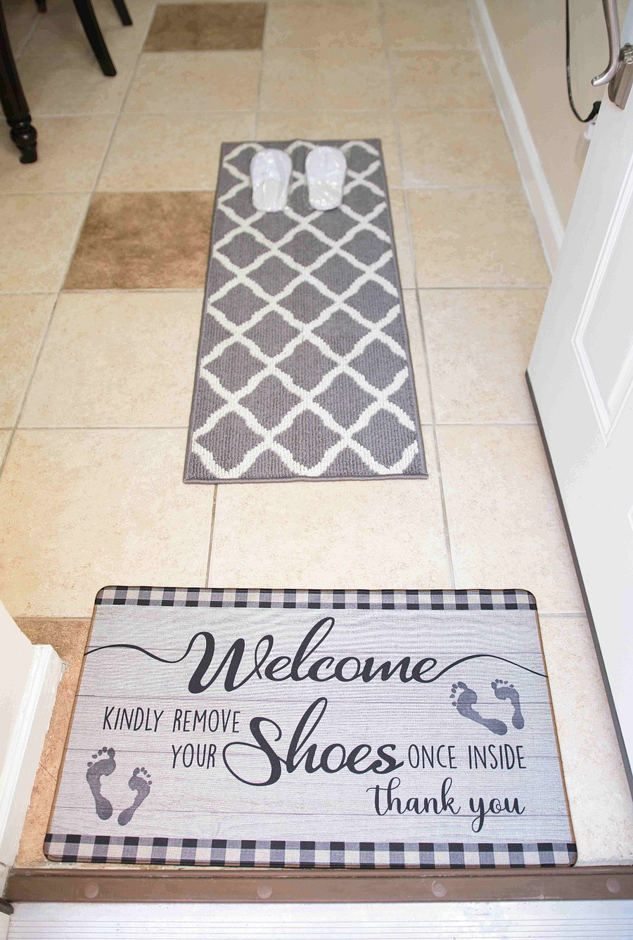 Welcoming entryway with a cozy floor mat and complimentary slippers ready for you, designed to make you feel at home from the moment you step inside.