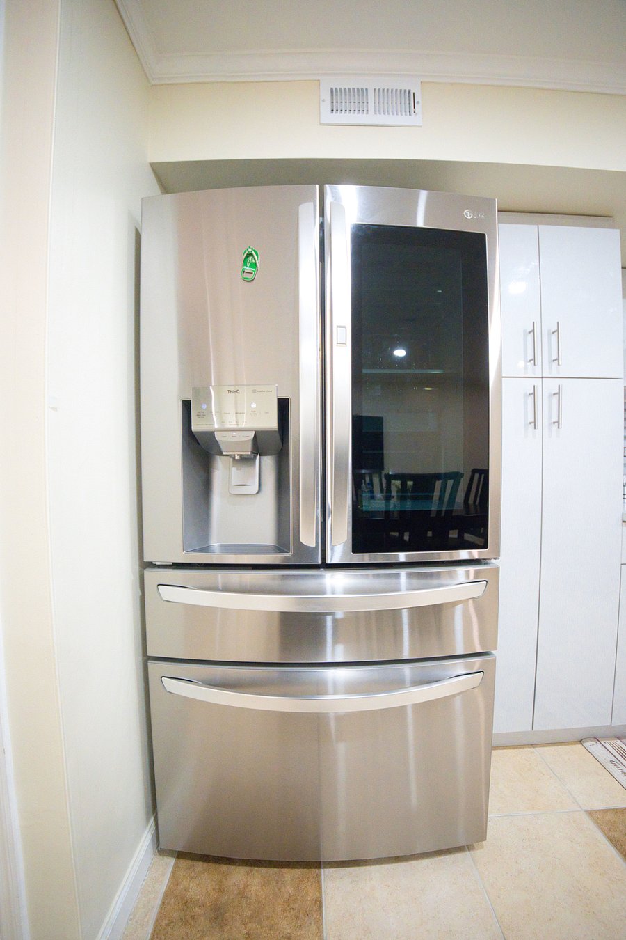 The smart refrigerator located in the kitchen, featuring a built-in freezer and convenient water and ice dispenser (perfect for keeping your drinks cool and staying refreshed throughout your stay).