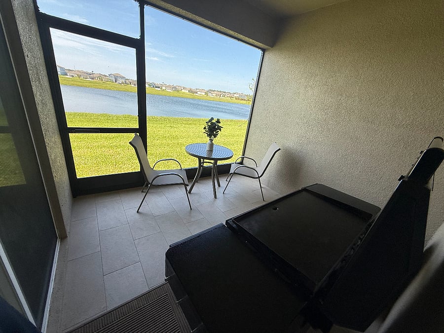 Screened patio in the backyard with a griddle