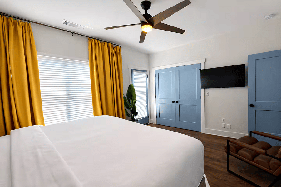 Located on the 2nd floor, the Beltline Suite features plush bedding and luxe linens, bedside charging, blackout curtains, dresser, a ceiling fan, Smart TV, bathroom and deck, all wrapped in thoughtfully curated designer interiors for a stylish stay.