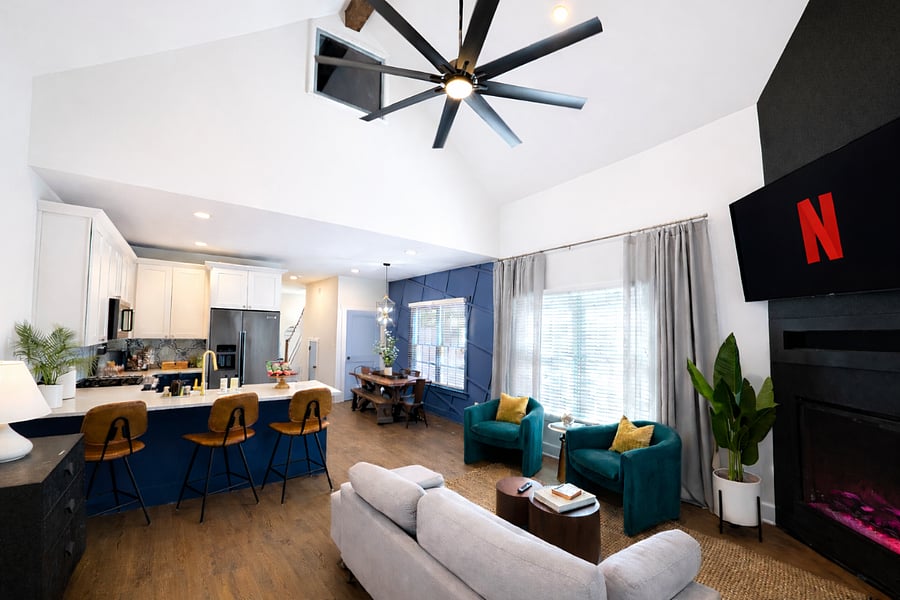 Step into your designer living room with high ceilings, bold accents, a cozy fireplace, and Smart TV. Relax in plush seating, or unwind in this warm, boutique-style gathering space. Cozy up with a movie and the fireplace, or play the provided games!