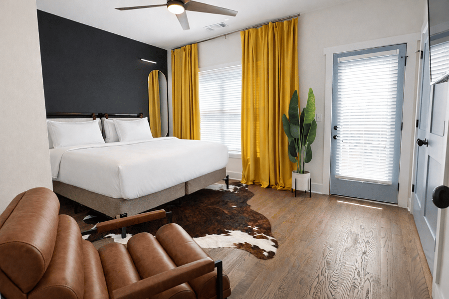 Located on the 2nd floor, the Beltline Suite features plush bedding and luxe linens, bedside charging, blackout curtains, dresser, a ceiling fan, Smart TV, bathroom and deck, all wrapped in thoughtfully curated designer interiors for a stylish stay.