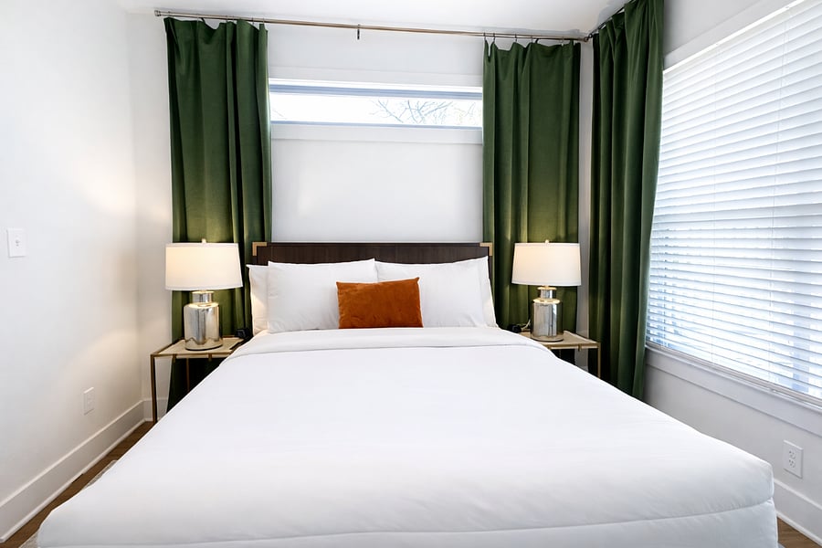 Located on the main floor, the Krog Suite is a relaxing queen room with hotel-level comfort. Enjoy plush linens, Smart TV, ceiling fan, bedside tables with charging ports, dresser, blackout curtains, and stylish designer decor.