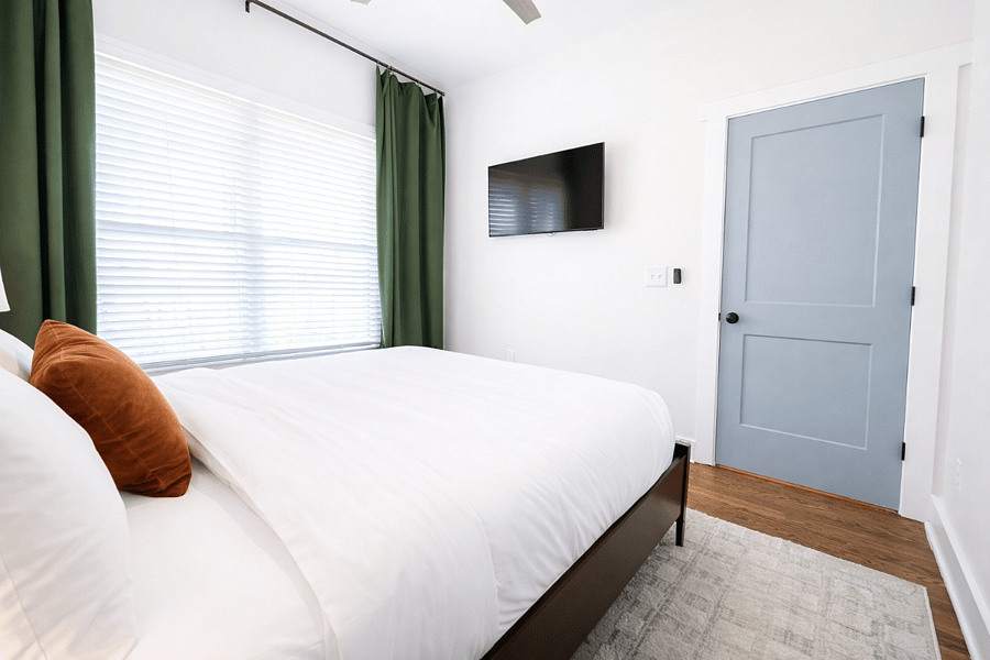 Located on the main floor, the Krog Suite is a relaxing queen room with hotel-level comfort. Enjoy plush linens, Smart TV, ceiling fan, bedside tables with charging ports, dresser, blackout curtains, and stylish designer decor.