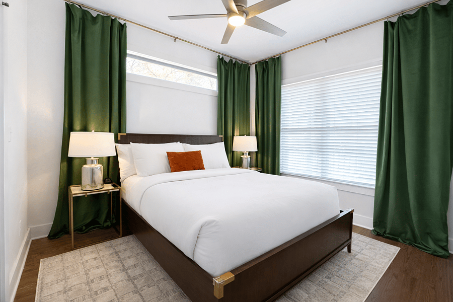 Located on the main floor, the Krog Suite is a relaxing queen room with hotel-level comfort. Enjoy plush linens, Smart TV, ceiling fan, bedside tables with charging ports, dresser, blackout curtains, and stylish designer decor.