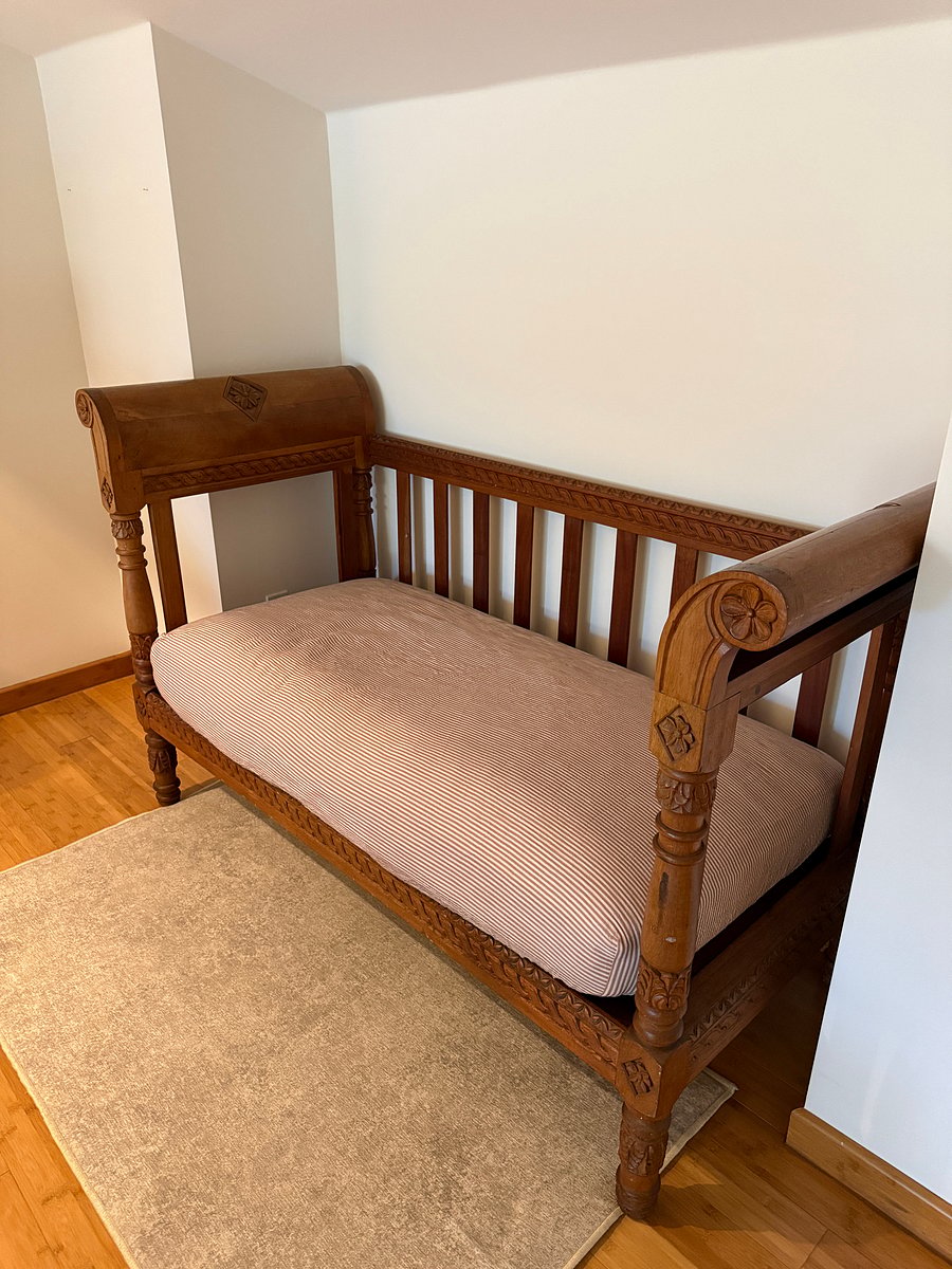 Hand-carved Guatemalan bench made from Honduran mahogany serves as a great luggage rack for packing and unpacking