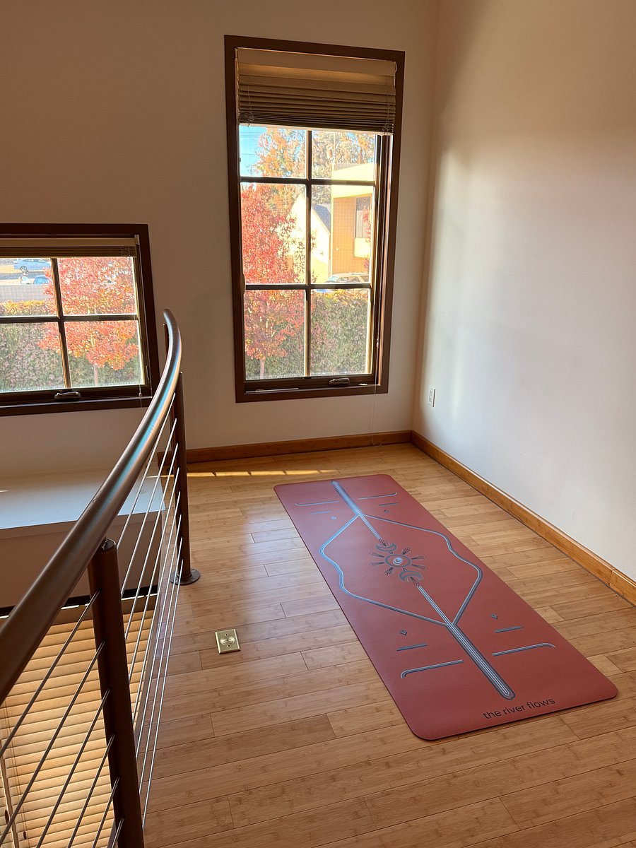 Yoga/stretch space or work space (table can be brought from downstairs to use as desk in loft if desired); decor is kept to a minimum to honor the openness of the space