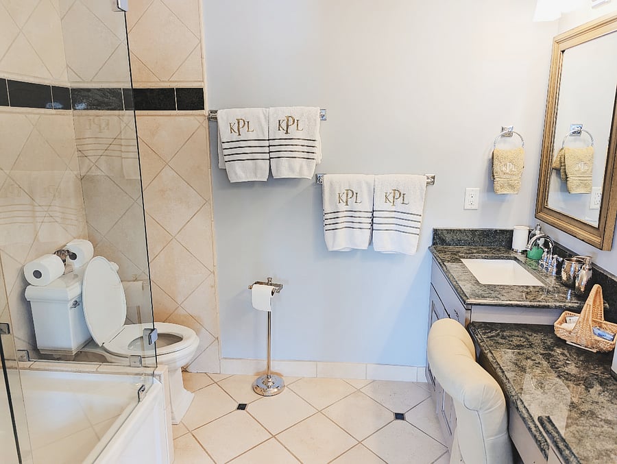 Ensuite Bathroom to first master bedroom has shower/tub combo. Vanity with seating.