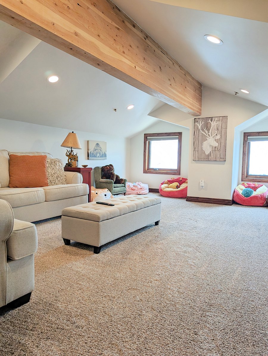 The spacious upstairs den area has a smart tv and large sectional. It is the perfect space for kids or a larger group to spread out in.