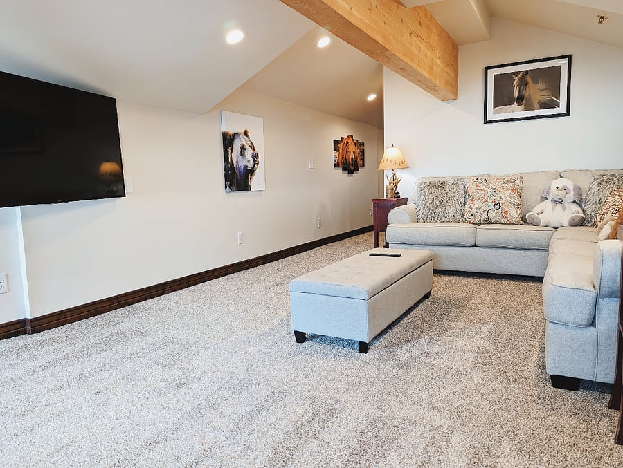 The spacious upstairs den area has a smart tv and large sectional. It is the perfect space for kids or a larger group to spread out in.