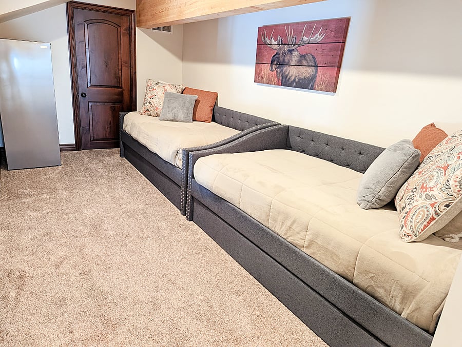 The two twin size trundle beds upstairs in the den area provide extra sleeping space for kids or a larger group. It is open to the stairs and upstairs den area. There is also a small refrigerator and half bathroom upstairs in this area.