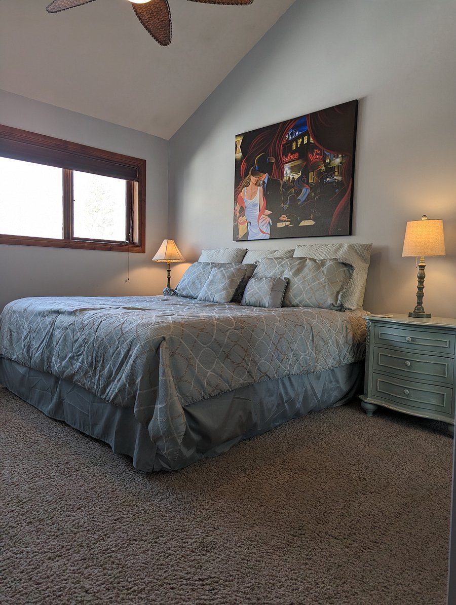The third bedroom has a king size bed with closet space, dresser and smart tv.