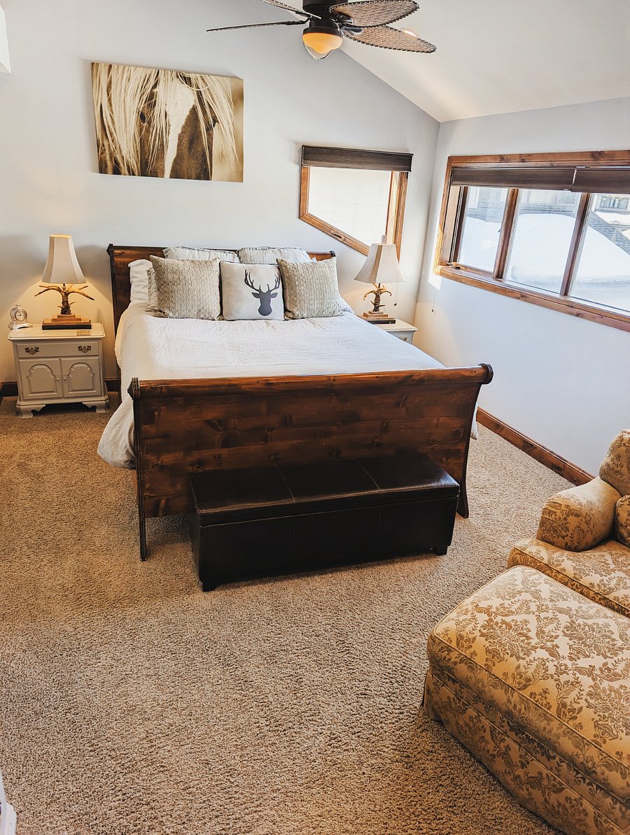 The 2nd master bedroom has a king size bed, closet space and a chair. It also has a full ensuite bathroom.