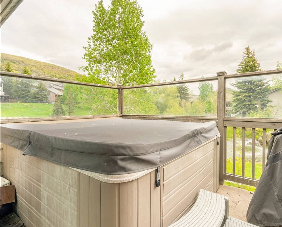 The private hot tub is on the deck of the condo. The grounds of the condo development in the summertime are green and flourishing with ponds and wildlife throught.