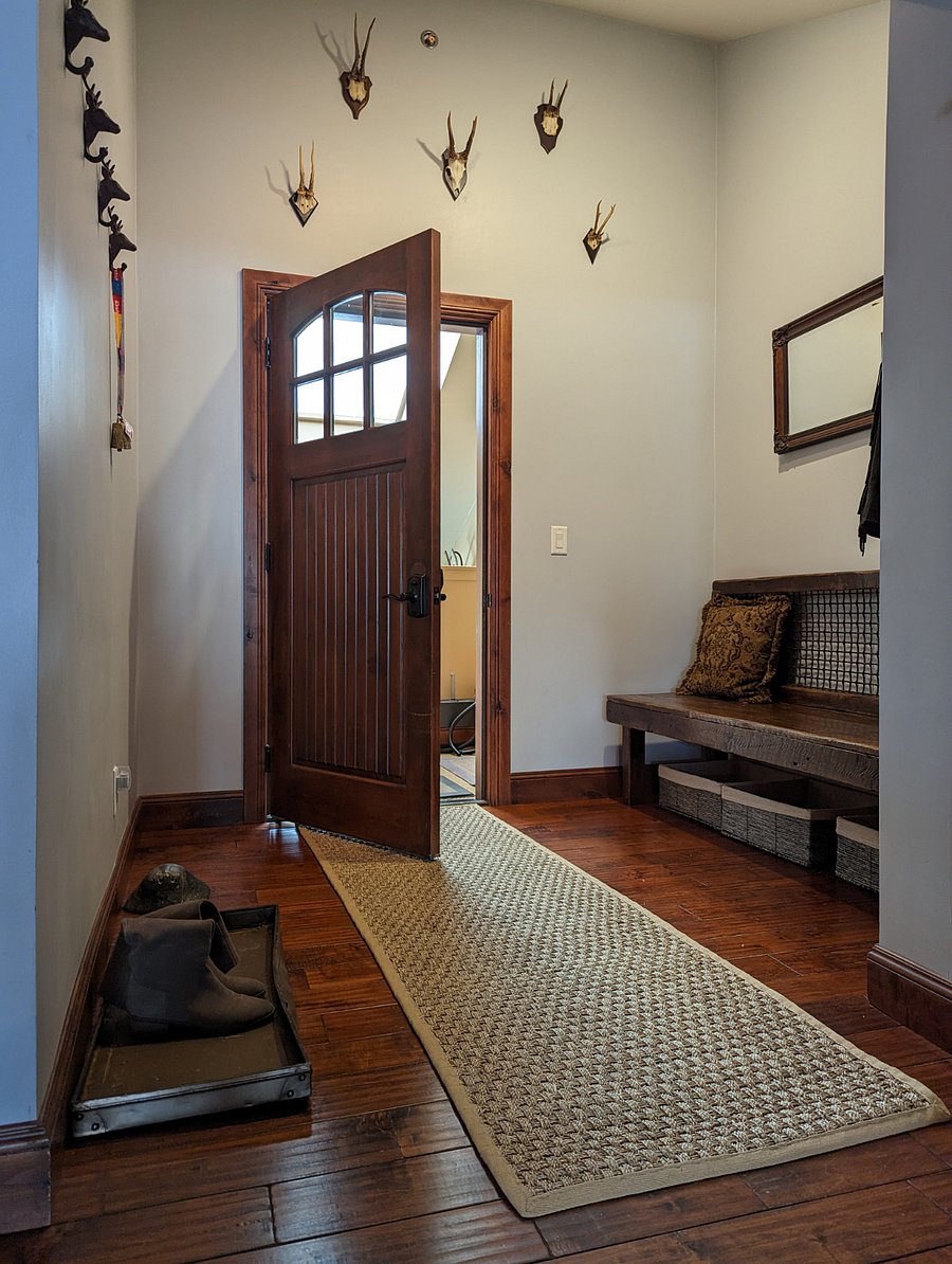 The interior front door to the condo is just inside of the interior seating area/mud room at the top of the stairs that lead from the exterior door of the condo.