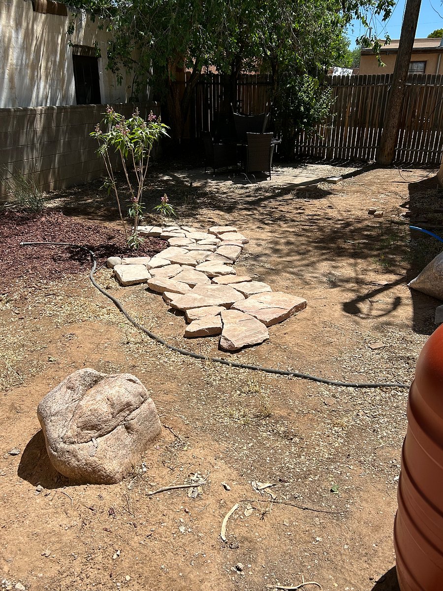 Backyard with landscaping underway. Enjoy the private back porch watching butterflies and hummingbirds as they visit the Desert Orchid and Spanish Broom.