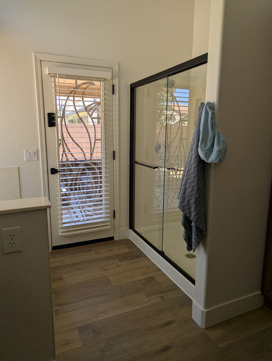 Master walk in shower with door to back covered patio