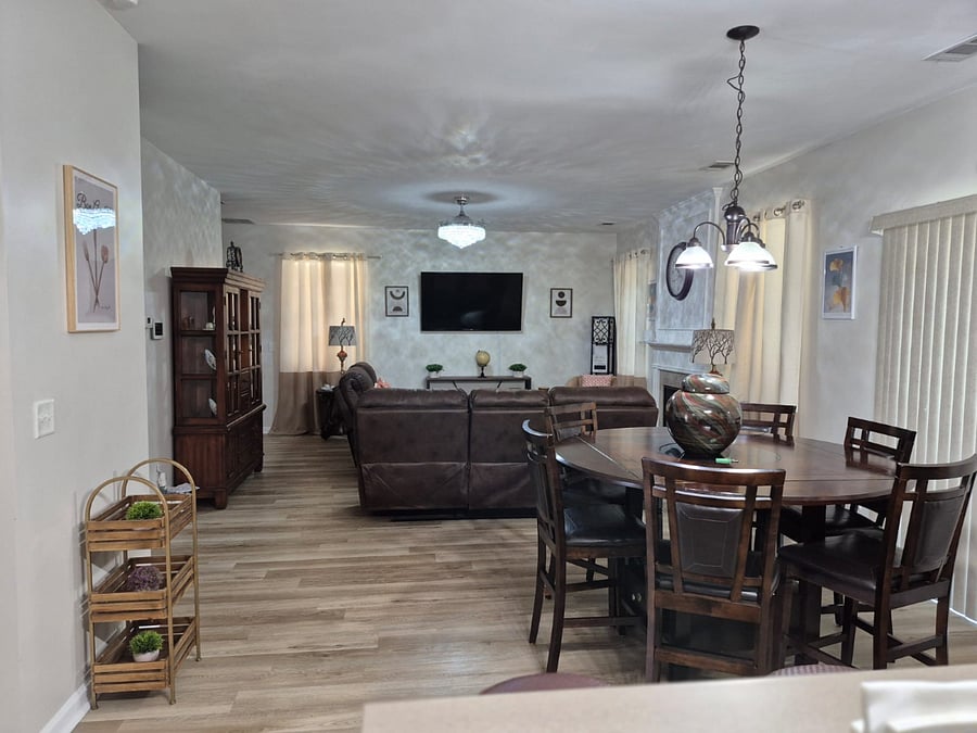 Landscape view of living room and eat in area. 
Powder room is located close to this area. 