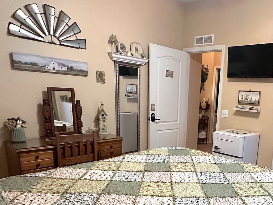 The view from the bed provides you perspective on the layout. While the bathroom is across the hall, the entire area is nestled back behind an large beautiful door so you will have the privacy it provides.