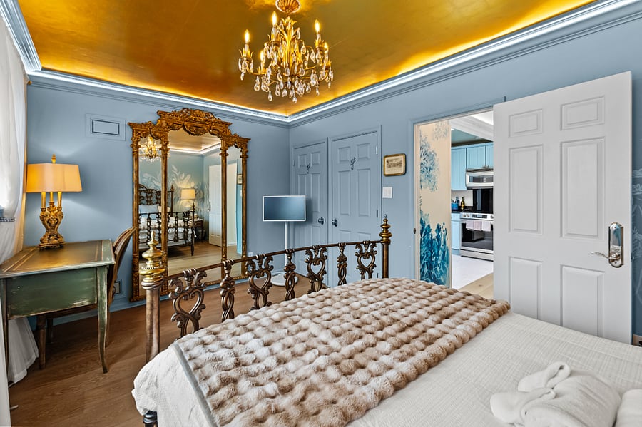 Floor to ceiling gilded mirror. There is a desk for remote work.