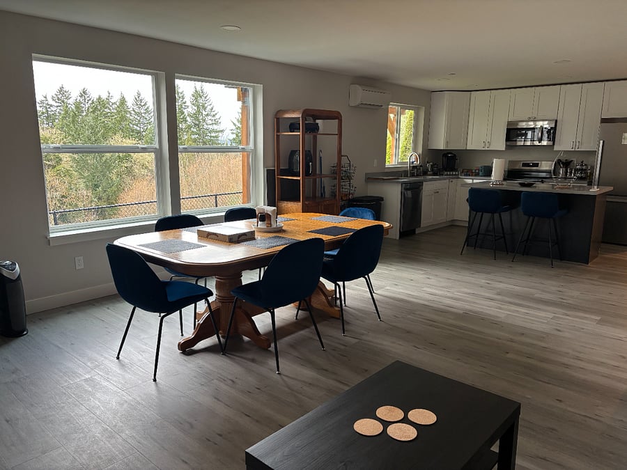 Dining room. The table has extra leaves underneath and there are extra chairs in the garage.