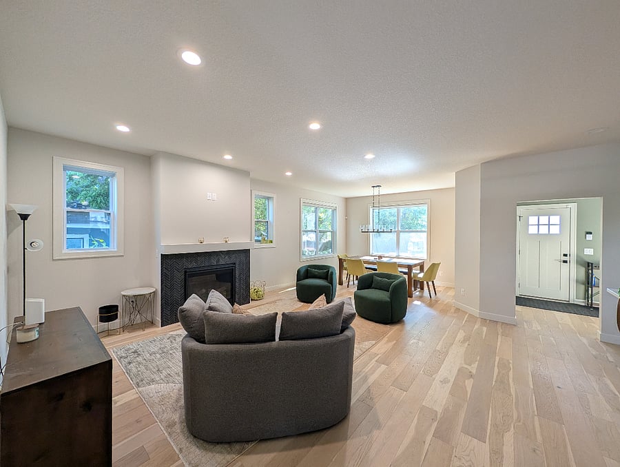 Open dining room, sitting area, and kitchen, with gas fireplace
