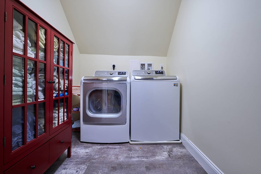 laundry room with oversized washer and dryer on upper level