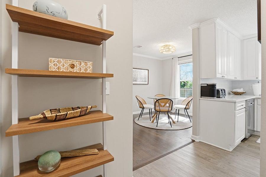 Bookshelf in hallway to Master Bedroom, looking into Dining room and Kitchen