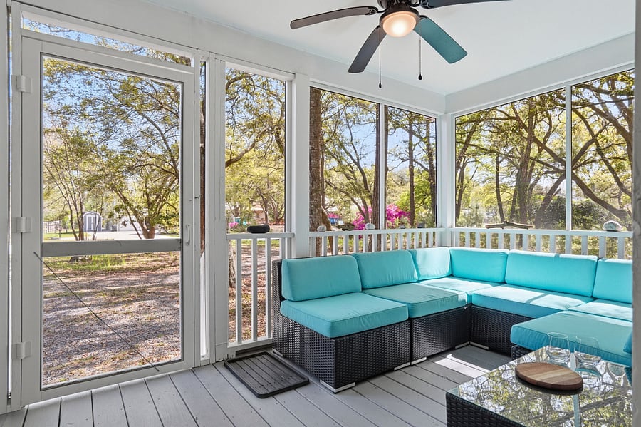 Screened-in front porch on house set back from street for lots of privacy.